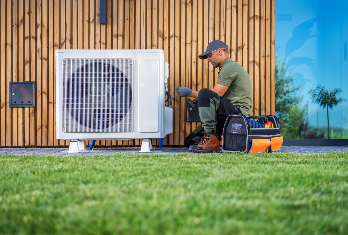 HVAC technician servicing an air conditioning unit