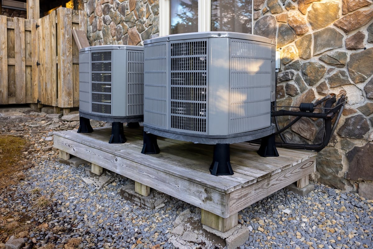 Outdoor dual zone heat pumps next to house