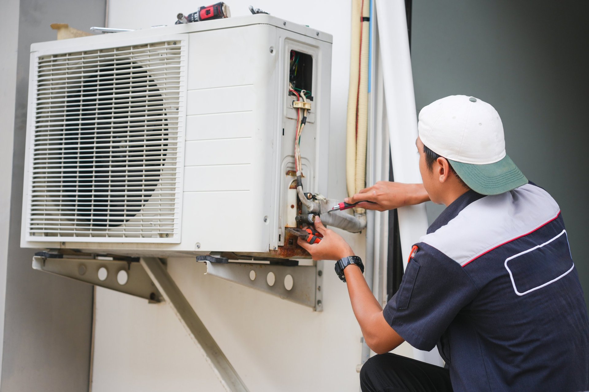 Repairman fixing air conditioning systems